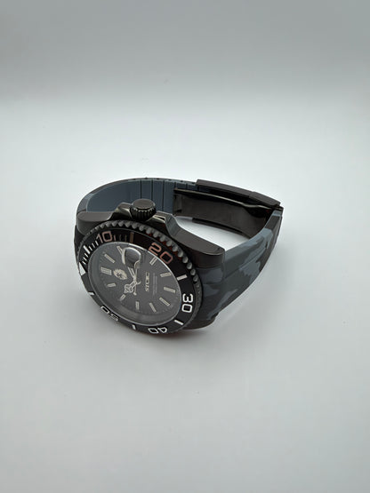 Blackout Diver resting at an angle, showing the camouflage strap and black case.