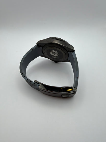 Blackout Diver rear view with a lion-engraved caseback and black clasp on its camouflage strap.