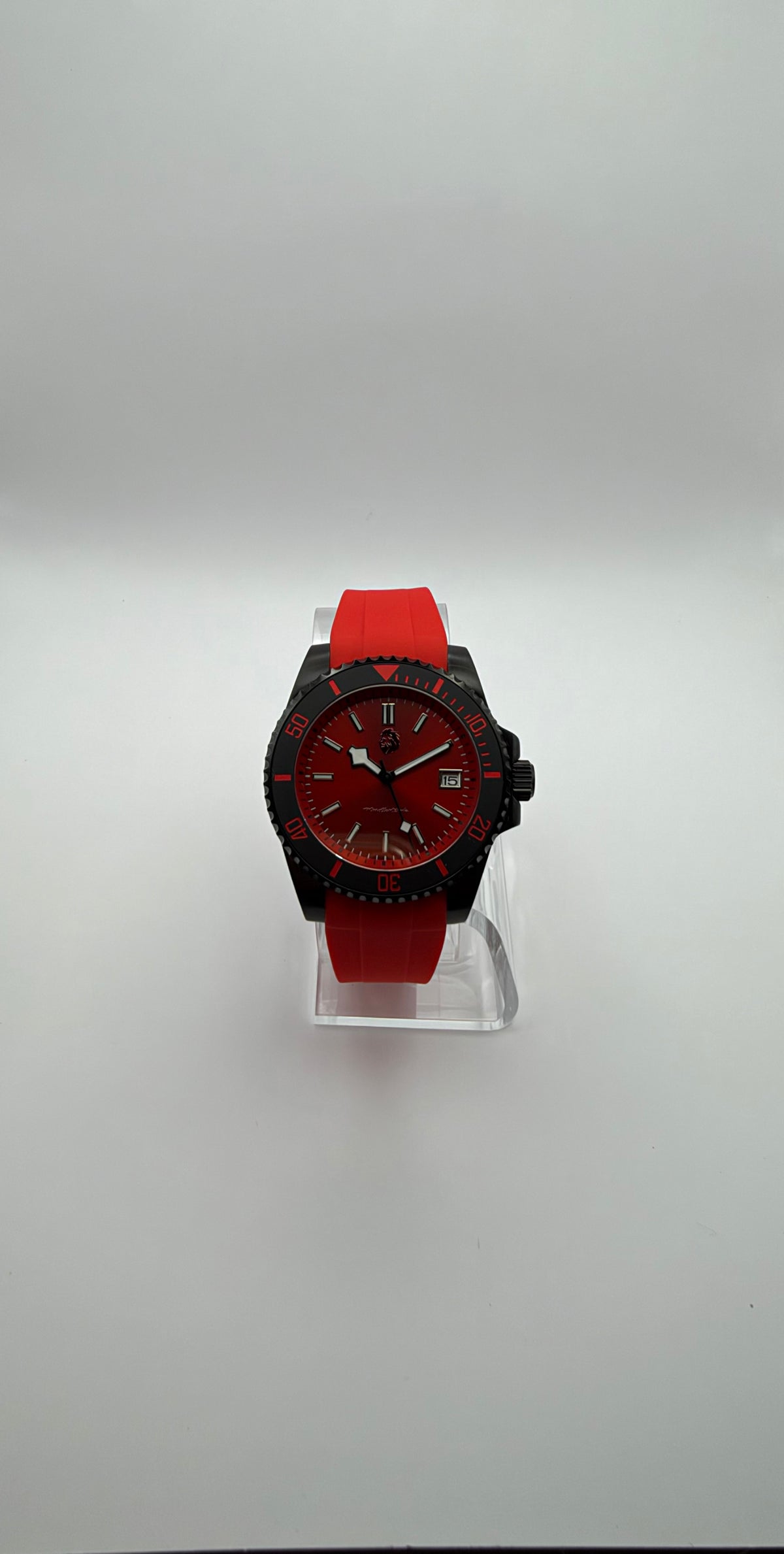 Pyra front view showing the red dial, date window, red strap and black case.
