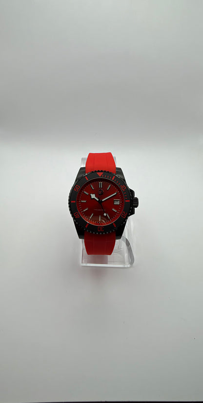 Pyra front view showing the red dial, date window, red strap and black case.