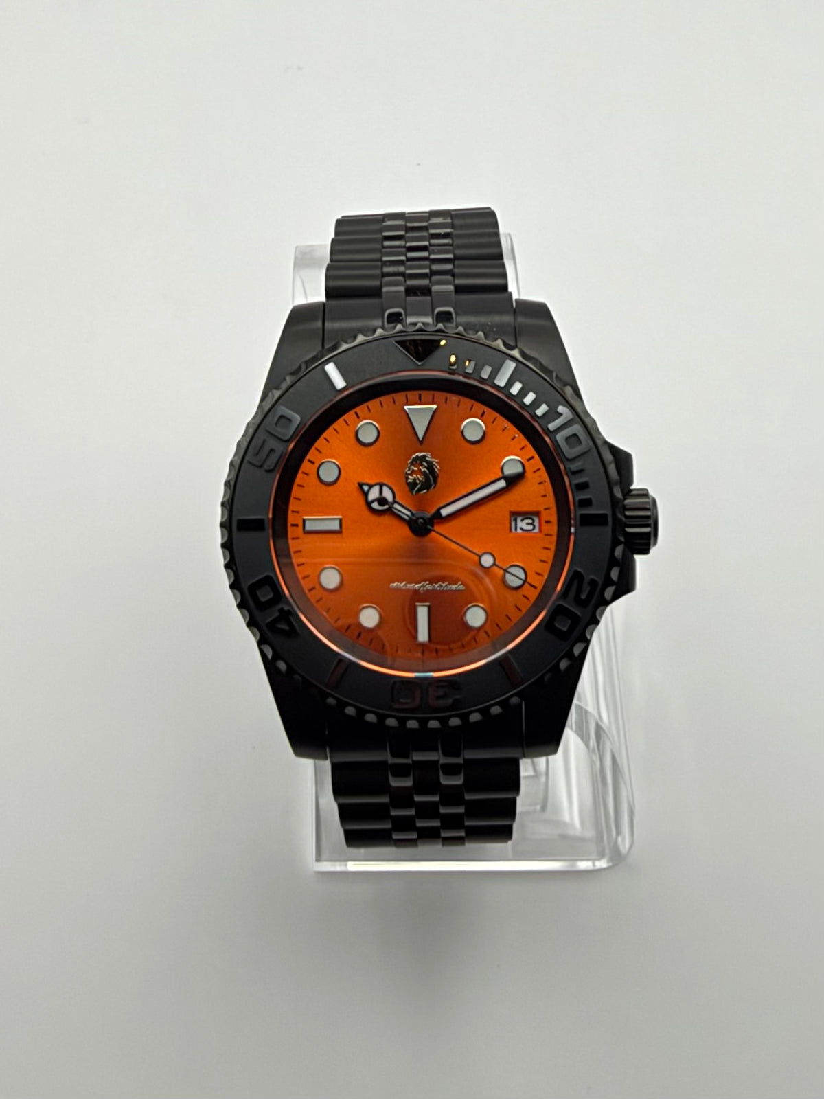 Ember Depth front view, with a bright orange dial, black bezel and black link bracelet.