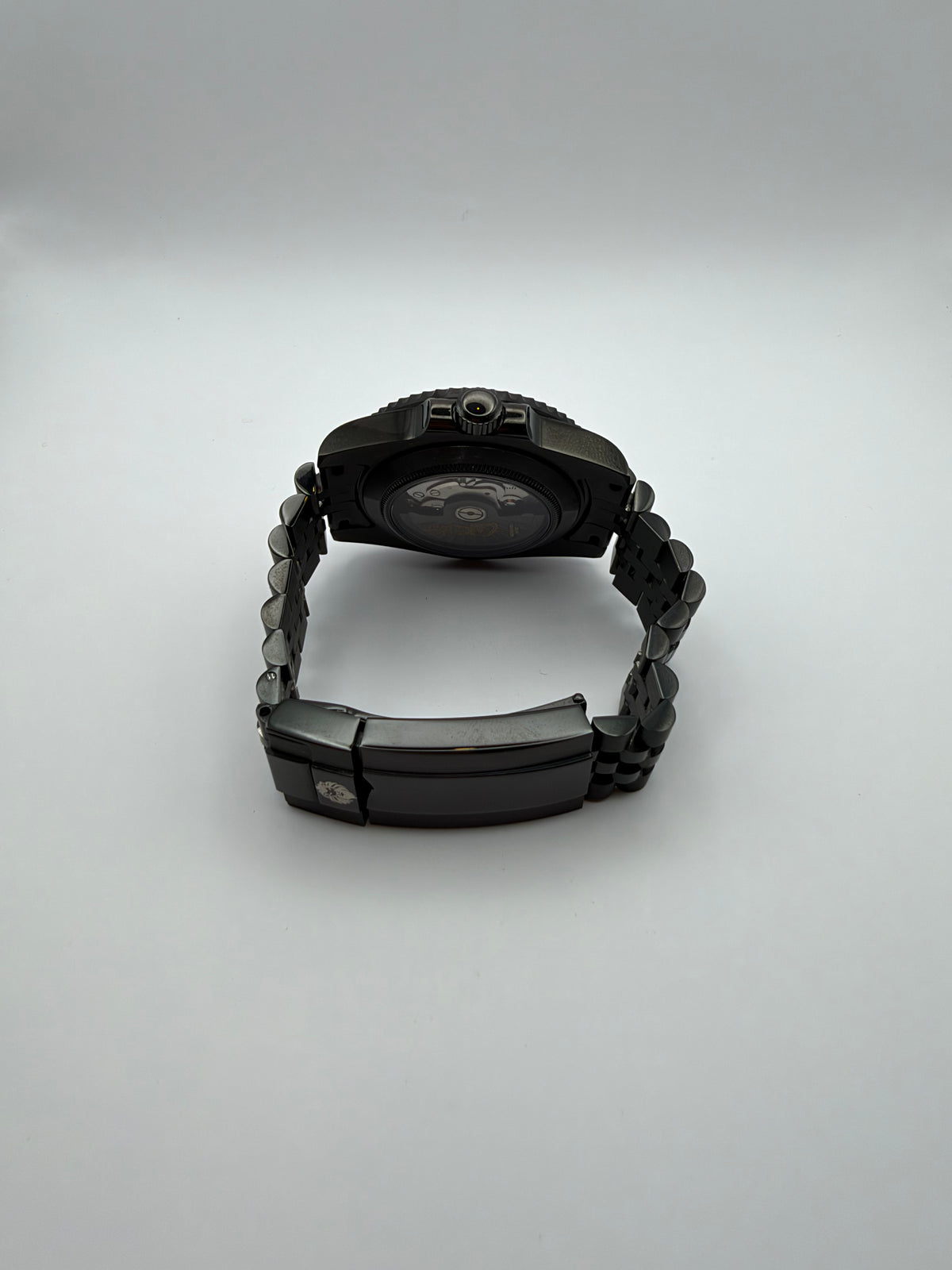 Ember Depth rear view showing a display caseback and black bracelet with a folding clasp.