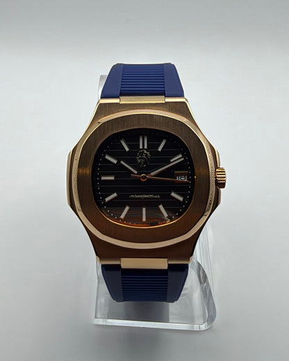 STOIC The Nocturne: Front view of the black dial, gold-tone case and blue strap.
