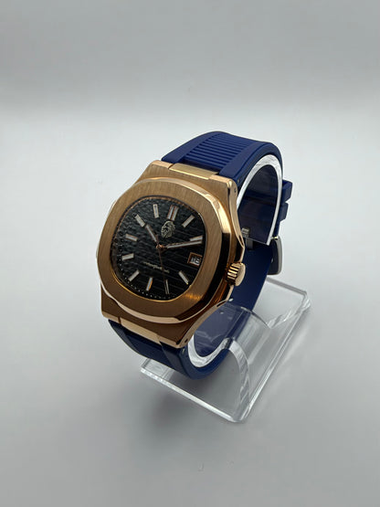 Nocturne at an angle, showing its gold-tone case, black dial and ribbed blue strap.