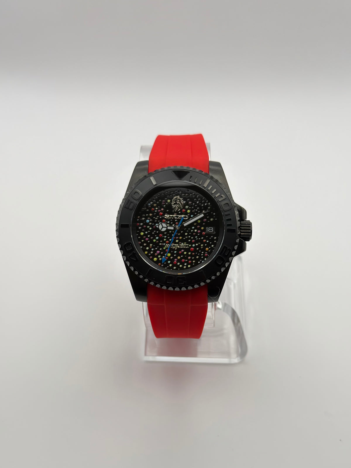 Memento Diver front view showing its dotted black dial, date window and red strap.