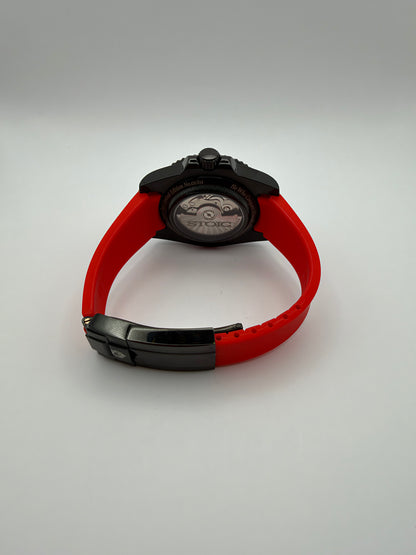 Memento Diver rear view showing the display caseback, red strap and black folding clasp.