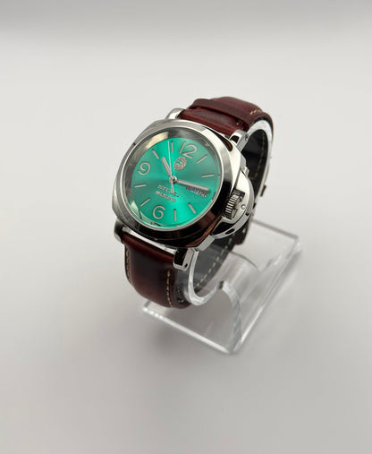 STOIC Arete Verde green dial watch with brown leather strap, angled front view