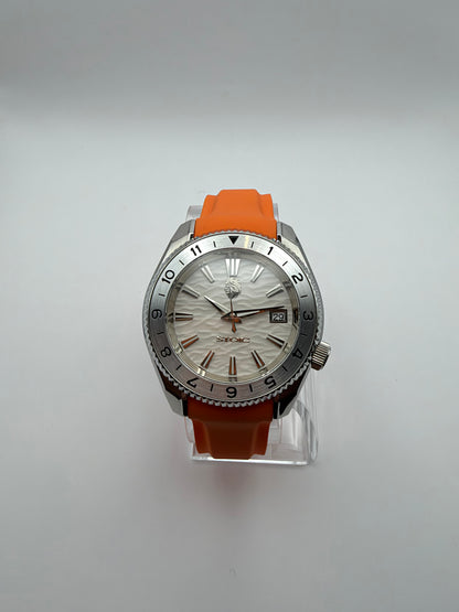 Equinox front view, with a white textured dial, silver-tone numbered bezel and orange strap.