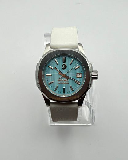 STOIC The Aether Aqua: Front view of the aqua dial and white strap.