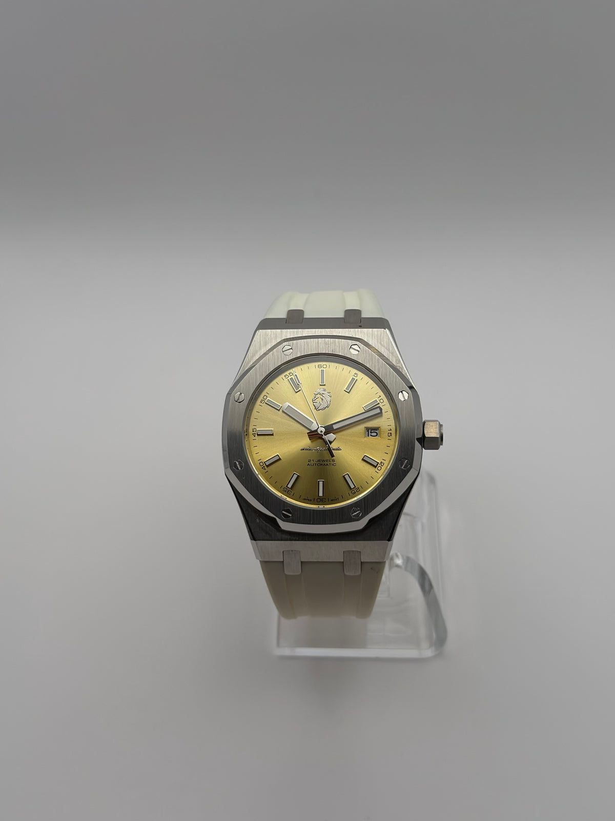 Thalassa Gold front view, with a gold-color dial, silver-tone octagonal bezel and cream-white strap.