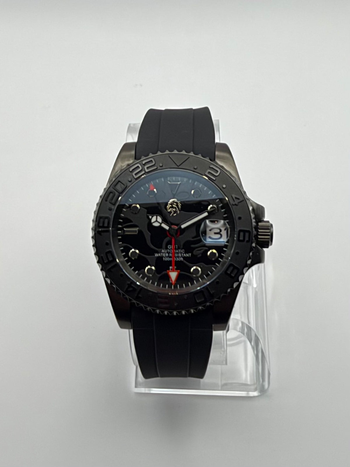 Revenant front view showing its dark patterned dial, red hand and black numbered bezel.