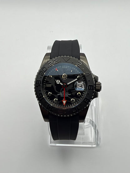 Revenant front view showing its dark patterned dial, red hand and black numbered bezel.