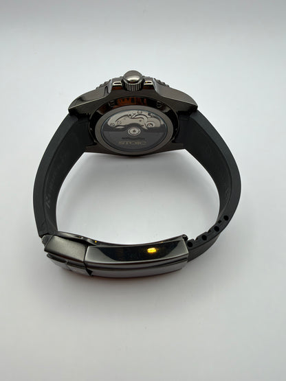 Revenant rear view with a display caseback and black strap with a dark folding clasp.