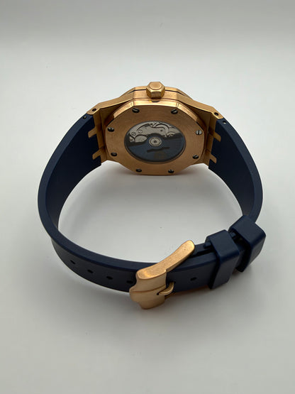 Meridian rear view showing a display caseback, dark blue strap and gold-tone buckle.