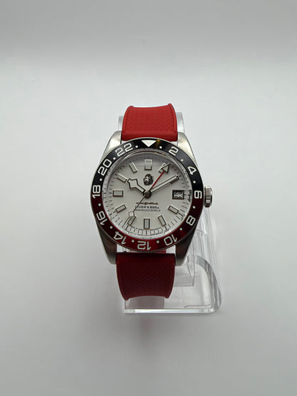 Valiant GMT front view showing the white dial, date window and black and red numbered bezel.