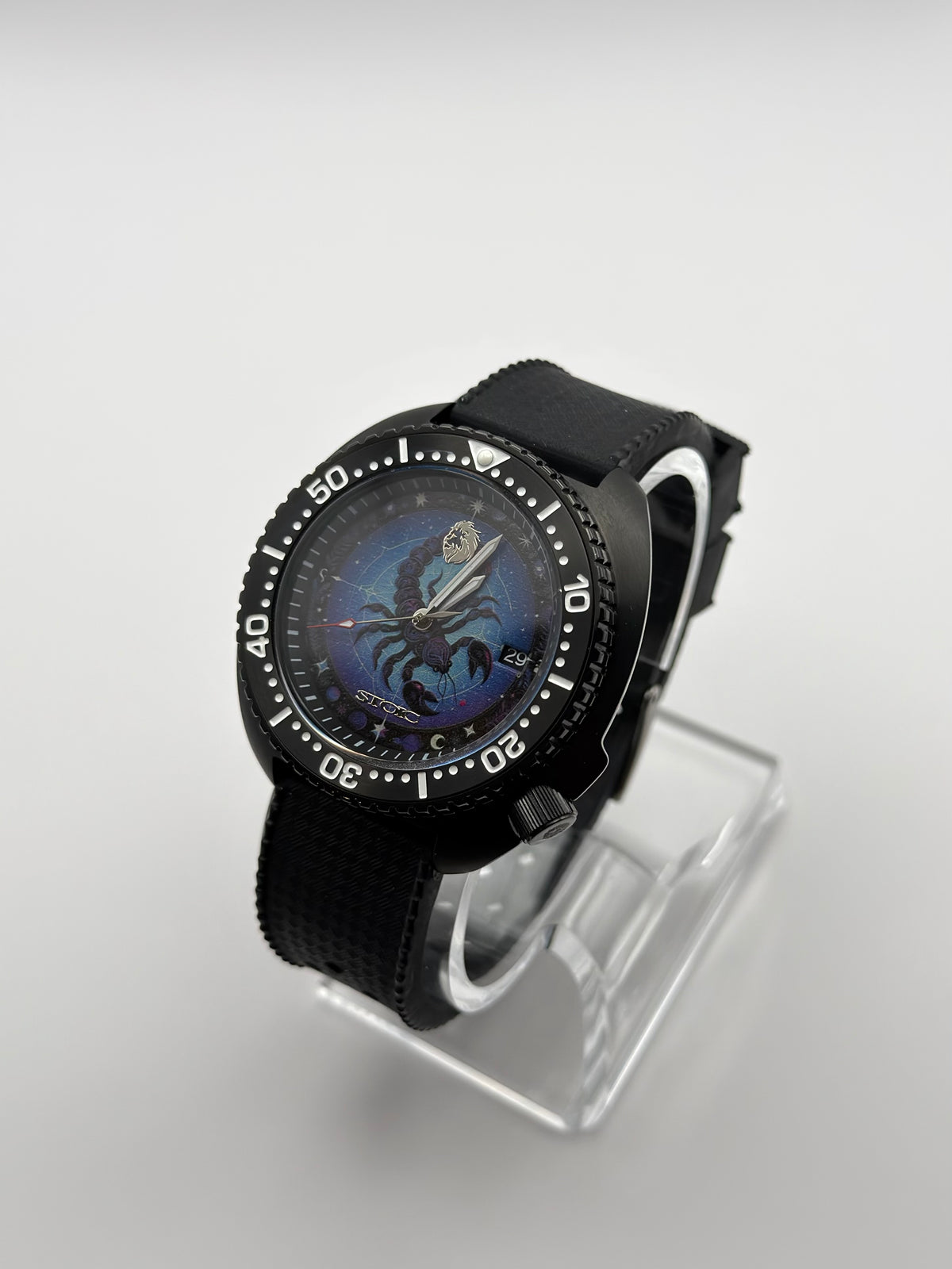 Scorpius at an angle, with a blue scorpion dial, black numbered bezel and textured black strap.