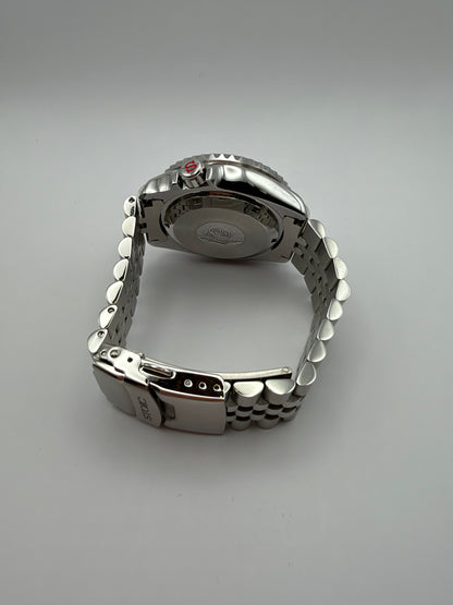Thalassa Orange rear view showing the solid caseback, silver-tone bracelet and STOIC-marked clasp.