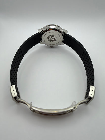 Voyager rear view with a lion-engraved caseback, black strap and open folding clasp.