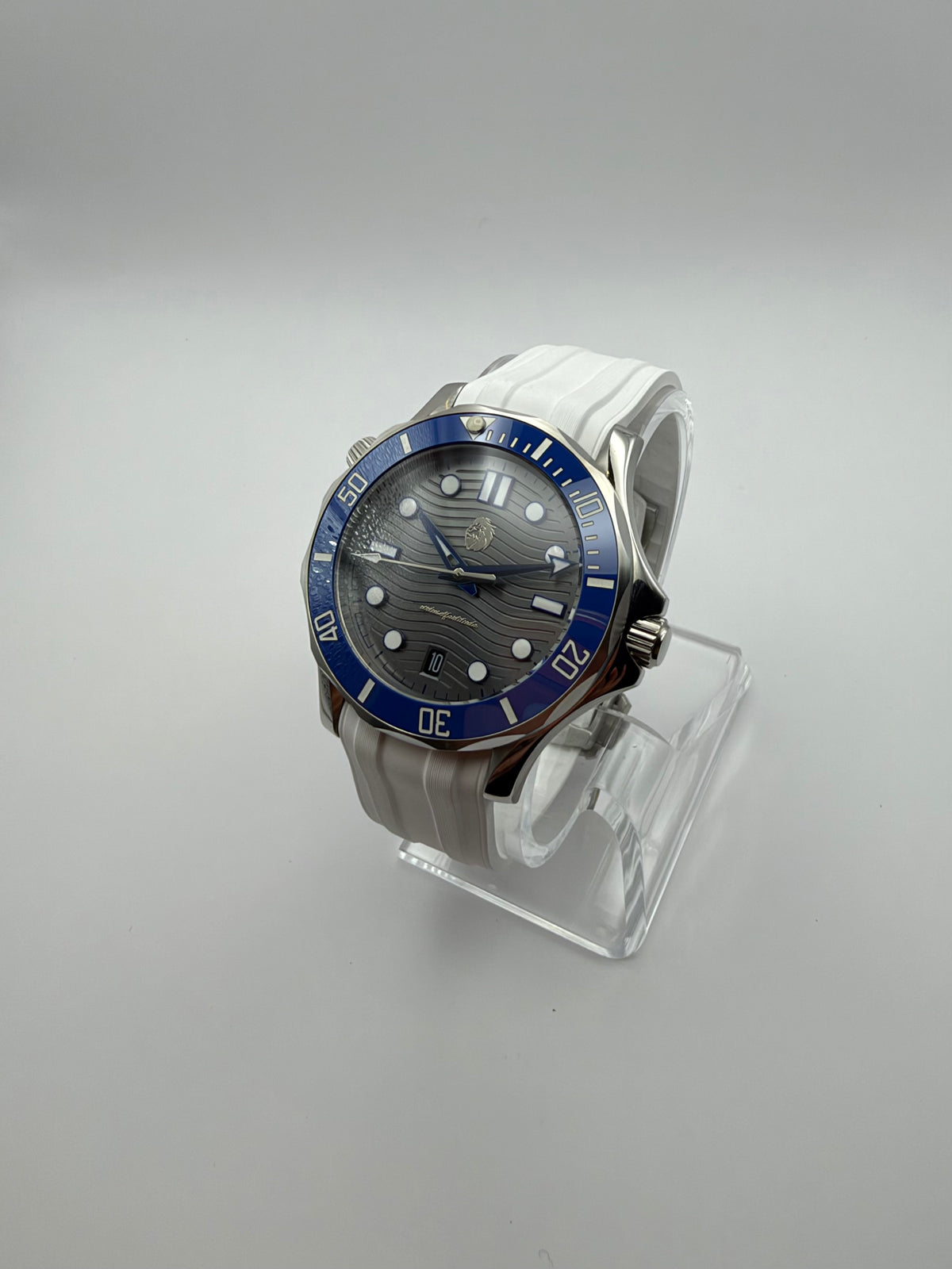 Thalassa Blue at an angle, with a gray wave-pattern dial, blue bezel and white strap.