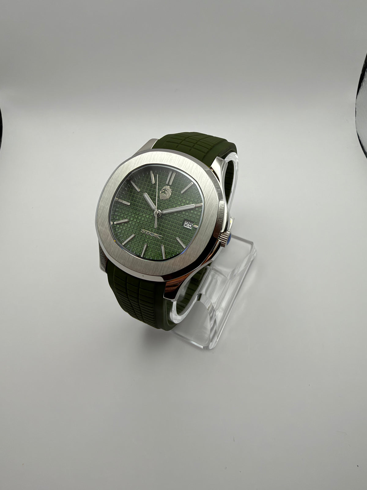 Viridian at an angle, with a green grid-pattern dial, silver-tone cushion case and green strap.