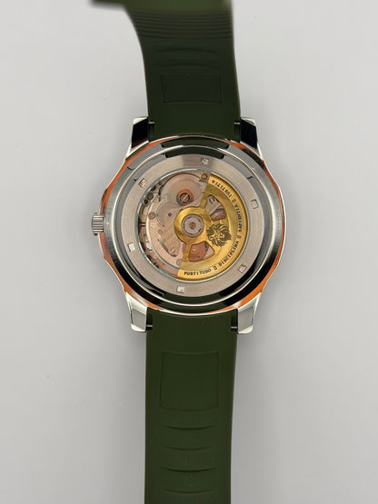 Viridian display caseback showing a gold-tone rotor and the green strap.