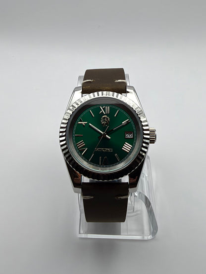 Verdant front view, with a green Roman-numeral dial, silver-tone fluted bezel and brown strap.